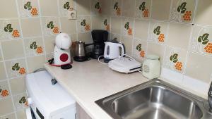 a kitchen counter with a sink and appliances on it at Skyros Euphoria House in Skiros