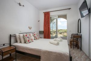 a bedroom with a bed and a window at Dimitris studios & apartments in Faliraki