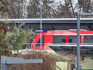 a red train is at a train station at Ferienwohnung in Erftstadt Phantasialand, Köln, Köln Messe, Eifel in Erftstadt