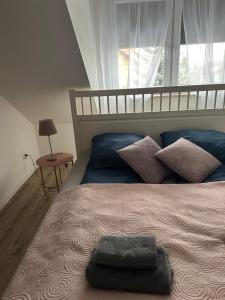 a bedroom with a large bed with a large window at Apartament Oksford 3 in Okszów