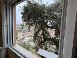 a window with a tree and a view of a city at SlabonHome Serrallo in Granada