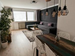 a living room with a couch and a table at Downtown Apartments Unterbilk in Düsseldorf