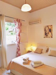 a bedroom with a large bed with a window at Alegria studios in Gaios
