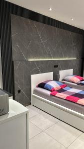 a bedroom with two beds in a room with a table at FEWO Cologne, Airport, City in Cologne
