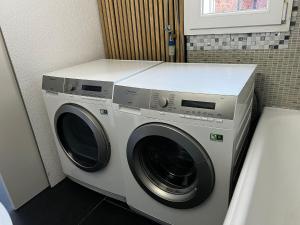 a washer and dryer sitting in a bathroom at Ferienwohnung in Unterterzen am schöne Walensee in Unterterzen