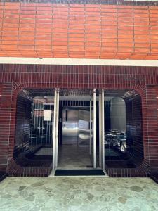 an entrance to a brick building with an open door at Apartamento en Pocitos in Montevideo