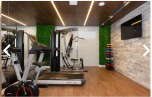 a gym with a treadmill and a exercise bike at Hotel Boutique Brava Mundo - SC in Itajaí