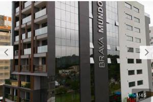 a building with a sign on the side of it at Hotel Boutique Brava Mundo - SC in Itajaí