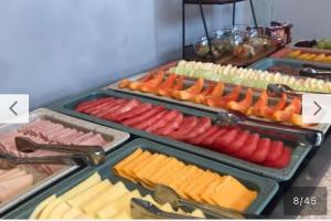a buffet with different types of meats and cheese at Hotel Boutique Brava Mundo - SC in Itajaí