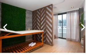 a room with a bed and a green wall at Hotel Boutique Brava Mundo - SC in Itajaí