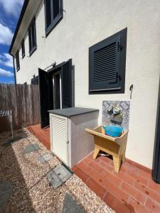 a patio with a table and a bench next to a building at Il PolpoLeo in Porto Azzurro Isola d'Elba in Porto Azzurro