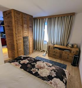 a bedroom with a bed with a flower pattern on it at Apartment 32 Crans-Montana in Crans-Montana