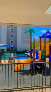 a playground in a building with a painting on the wall at Apartamento Cuiabá in Cuiabá