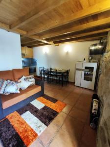 a living room with a couch and a kitchen with a table at Refugio d'Anita Douro Valley House in Barcos