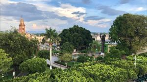 a cityscape of a park with a clock tower at Hotel Plaza Rioverde in R&iacute;o Verde