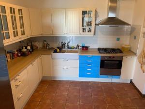 a kitchen with white cabinets and a stove top oven at Villa Sandra in Stintino