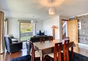 a living room with a dining room table and chairs at Villa Calçada in Santa Cruz