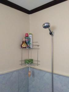 a corner of a bathroom with a shower with a shelf at Casa Esmeralda in Lupao