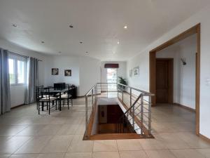 a living room with a staircase and a table at Villarelva in Ponta Delgada