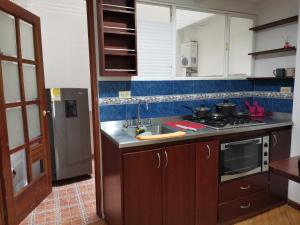 a kitchen with a sink and a stove at aparta-estudio norte de Tunja cristales in Tunja