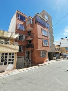 a brick apartment building on the corner of a street at aparta-estudio norte de Tunja cristales in Tunja