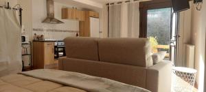 a living room with a couch and a kitchen at Apartamentos Virgen de Tironcillo in Cuzcurrita-Río Tirón