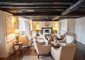 a living room with white furniture and a fireplace at Findon Manor Hotel in Worthing