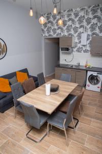 a table and chairs in a living room with a kitchen at BIG CENTRAL CITY APARTMENT in Berlin