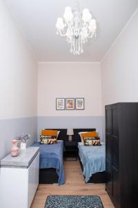 a bedroom with two beds and a chandelier at BIG CENTRAL CITY APARTMENT in Berlin