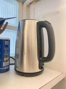 a metal kettle sitting on top of a counter at Super appartement 3T proche Tour Eiffel in Paris