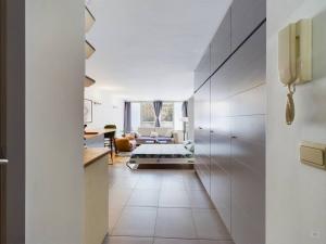 a hallway leading to a living room with a couch at Studio near Place stéphanie in Brussels