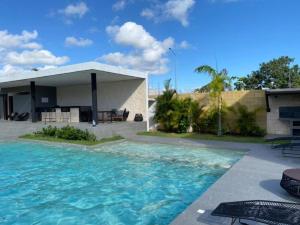 a swimming pool in front of a house at Paraíso Casa Turquesa Playa del Carmen in Playa del Carmen
