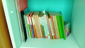 a row of books sitting on a shelf at A parada da Ribeira in Ourense