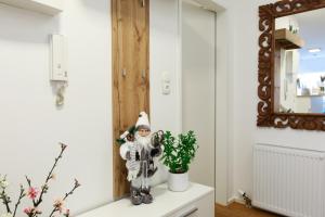 a santa clause sitting on a dresser in a room with a mirror at Wohlfühlapartment 24 in Götzis