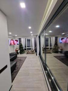 a hallway of a living room with christmas trees at Eco Penthouse&rooftop terrace. in Chişinău