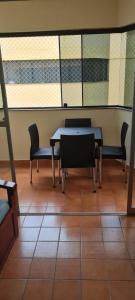 a dining room with tables and chairs and windows at Cobertura Parque das Aguas in Caldas Novas
