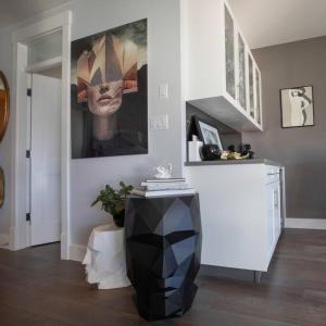 a living room with a picture of a mask on the wall at Mountain Serenity Meets Luxury in Squamish