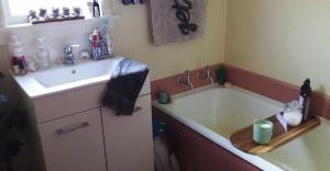 a bathroom with a bath tub and a sink at Blissful Rental in Motueka