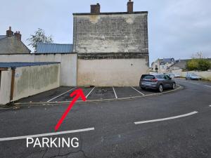 a car parked in a parking lot next to a building at studio centre-ville agréable in Vendôme