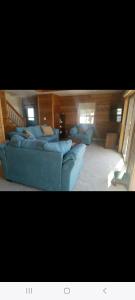 a living room with a blue couch and two couches at Sunset in Copake Falls