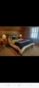 a bedroom with a large bed and a table at Sunset in Copake Falls