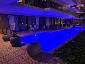 a swimming pool with blue lighting in a building at Costa Vista- Standard bedroom flat#501 with private pool- kololi sands in Sere Kunda