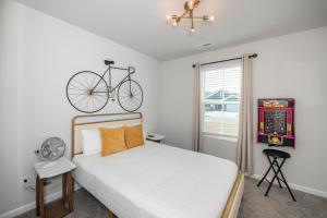a bedroom with a bed with a bike on the wall at Cozy Coastal Home Near Beaches, Shops, Restaurants in Southport