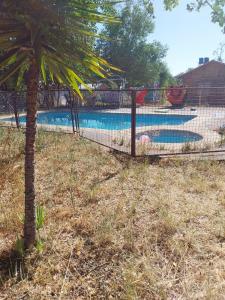 a fence in front of a swimming pool at Cabaña en Quillón in Quillón