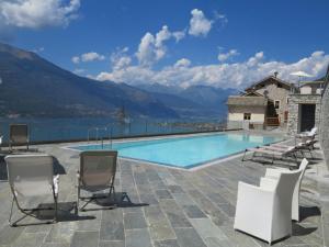 a swimming pool with chairs and a view of the mountains at Lavanda house - breathtaking view - in Bellano