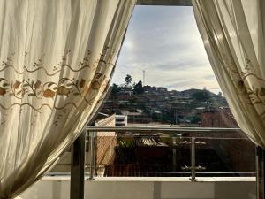 a window with curtains and a view of a city at Hermoso apartamento lindas vistas in Santuario