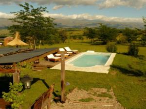 a swimming pool in the middle of a yard at Puesto Potrillos in Villa Yacanto