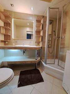 a bathroom with a sink and a shower at Apartament pod Basztą in Muszyna