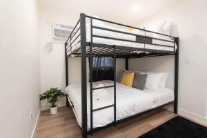 a bedroom with a black bunk bed with white sheets at Fun 5 Bedroom House Near DTLA in Los Angeles