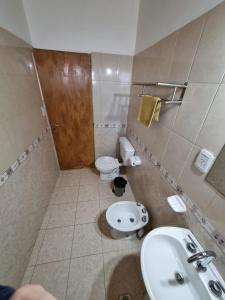 a bathroom with a sink and a toilet at Cuarta División Apartments in Malargüe +6 photos